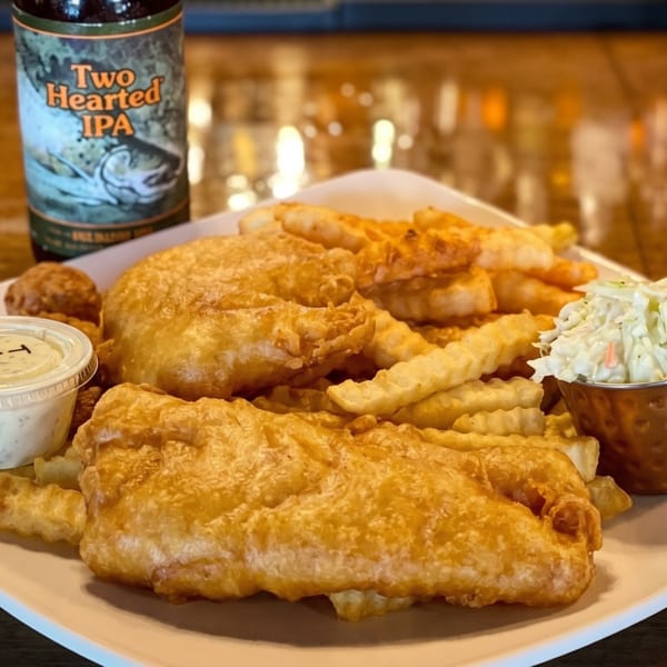 Fish and chips with coleslaw, tartar sauce, and a bottle of Two Hearted IPA.