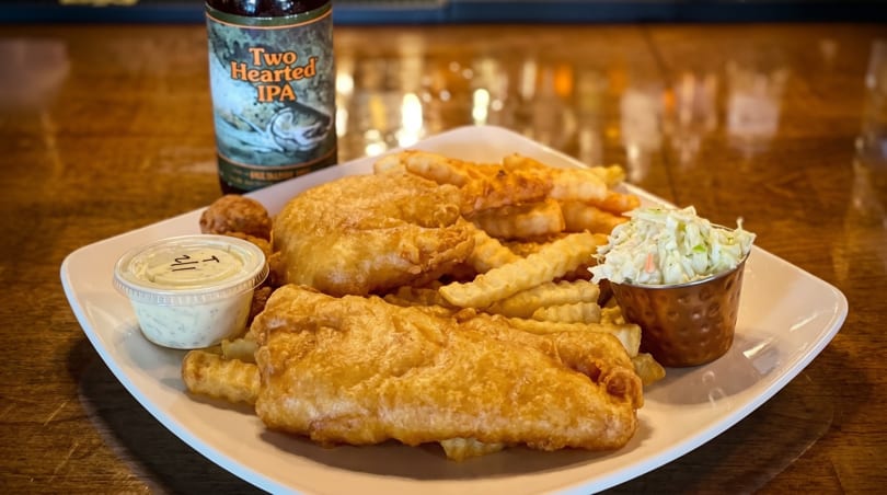 Fish and chips with coleslaw, tartar sauce, and a bottle of Two Hearted IPA.
